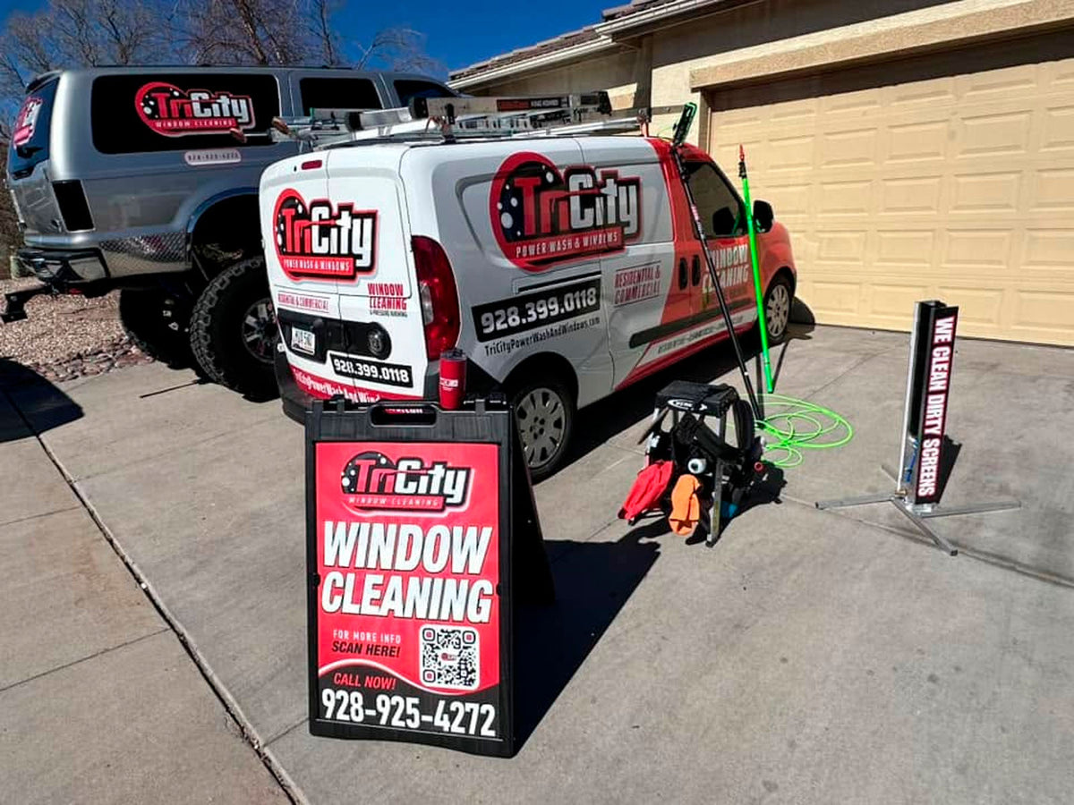Tri City Window Cleaning A-frame sign with branded service van and equipment setup in driveway, showcasing matching red and black design, printed by WCR Marketing.