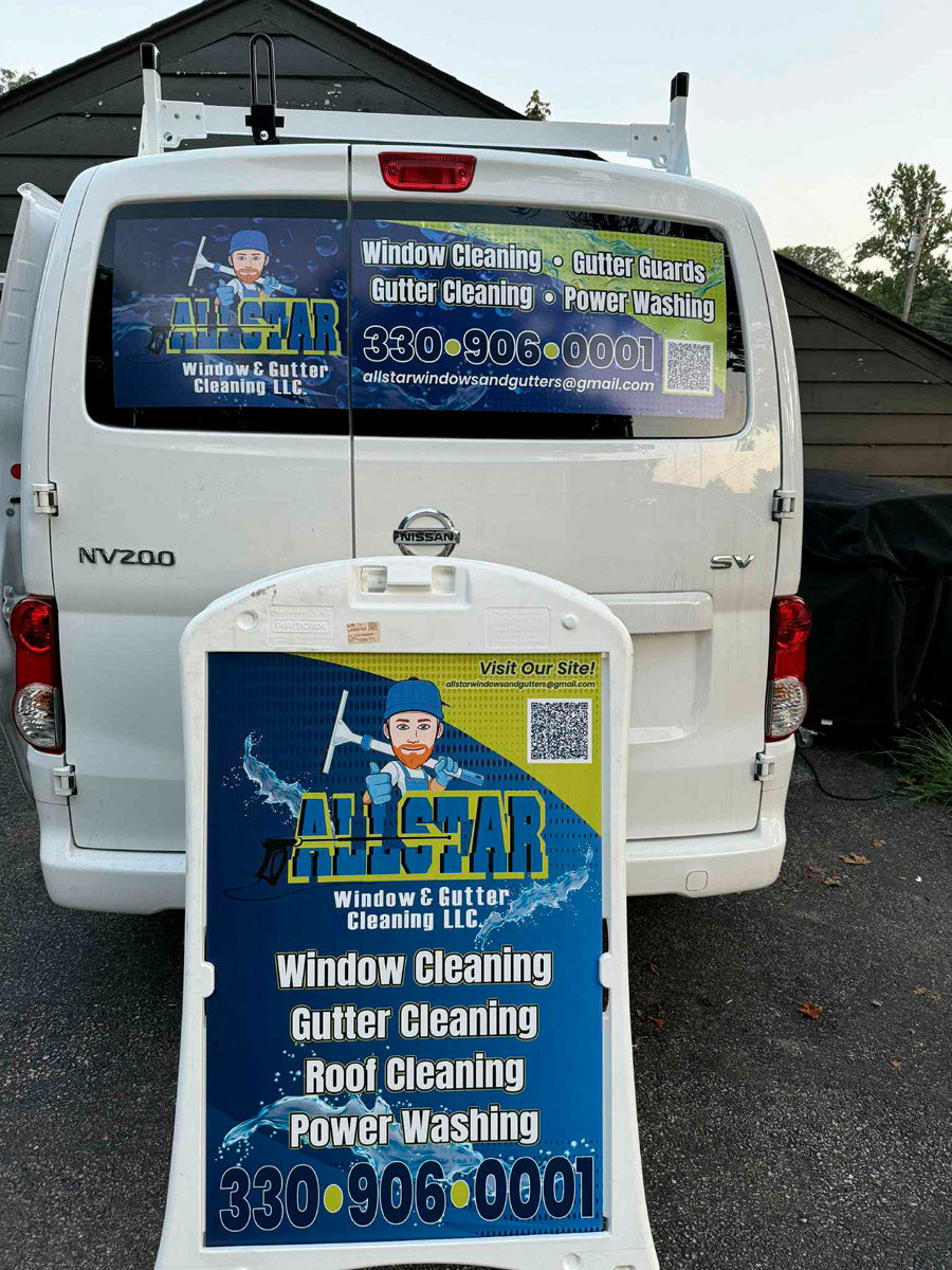 All Star Window & Gutter Cleaning A-frame sign advertising window, gutter, roof cleaning, and power washing in front of a wrapped service van, printed by WCR Marketing.