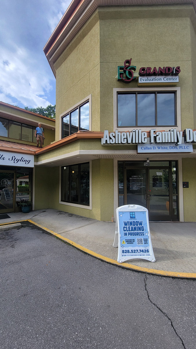 Clear Choice Window Cleaning A-frame sign outside Asheville Family Dentistry, promoting window cleaning in progress during commercial project, printed by WCR Marketing.