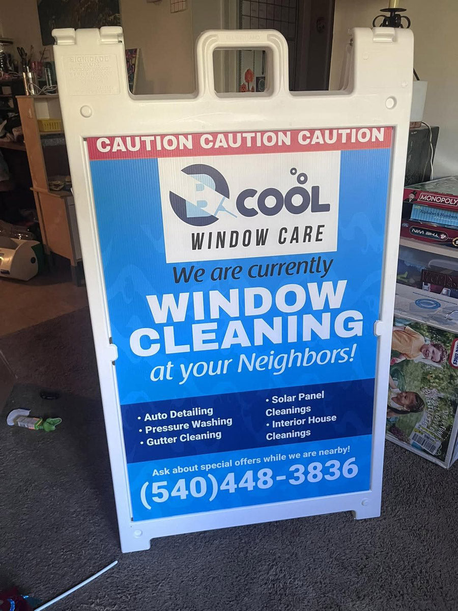 Blue and white A-frame sign for Cool Window Care advertising window cleaning and pressure washing services, printed by WCR Marketing.