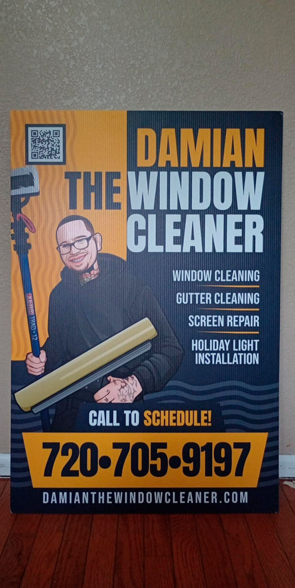 Indoor product photo of Damian The Window Cleaner A-frame sign with illustrated mascot, service list, and bold call-to-schedule number, printed by WCR Marketing.