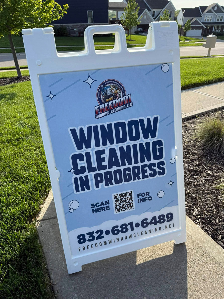 Freedom Window Cleaning “Window Cleaning In Progress” A-frame sign positioned on sidewalk in residential area, printed by WCR Marketing.