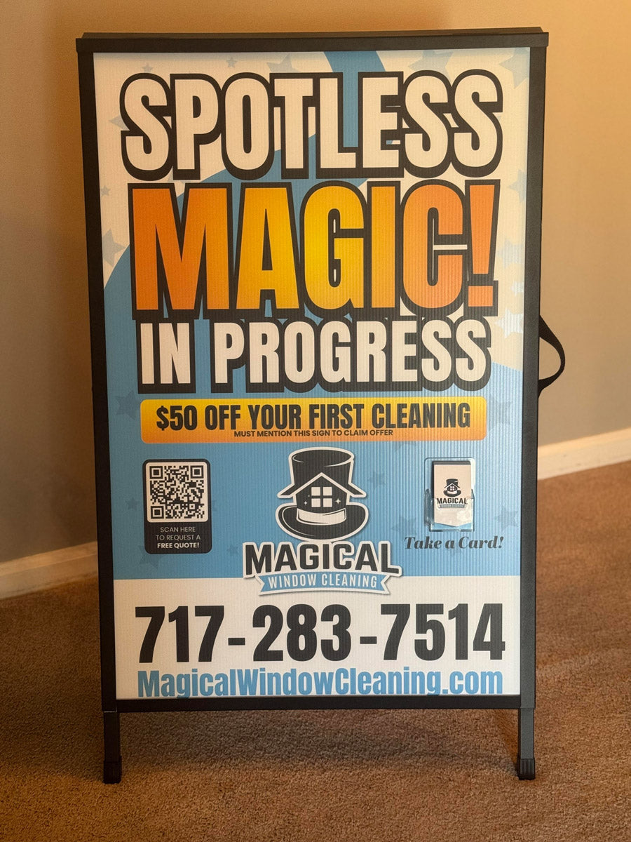 Magical Window Cleaning A-frame sign indoors with bold “Spotless Magic in Progress” headline promoting $50 off first cleaning, printed by WCR Marketing.