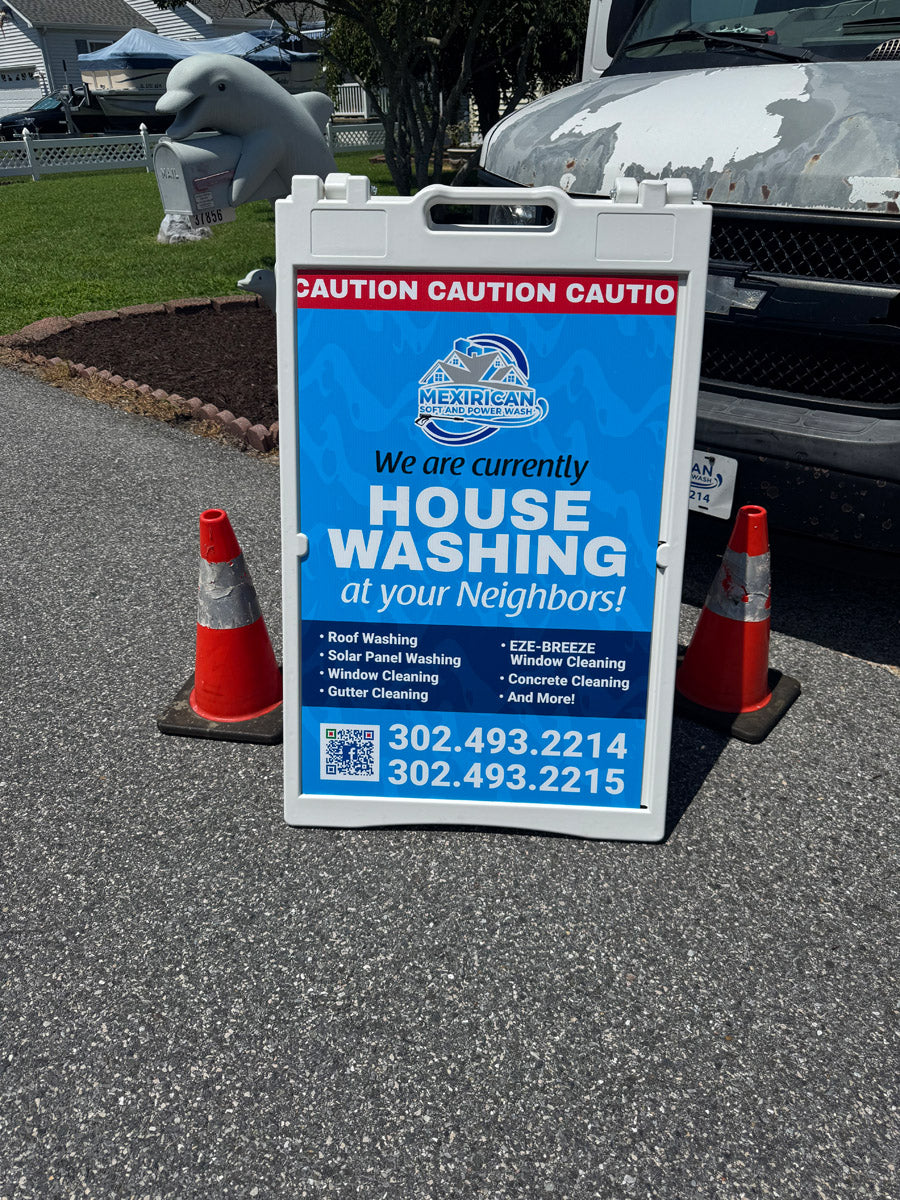 Mexirican Soft and Power Wash A-frame sign reading “House Washing at Your Neighbors,” placed beside traffic cones and work truck, printed by WCR Marketing.