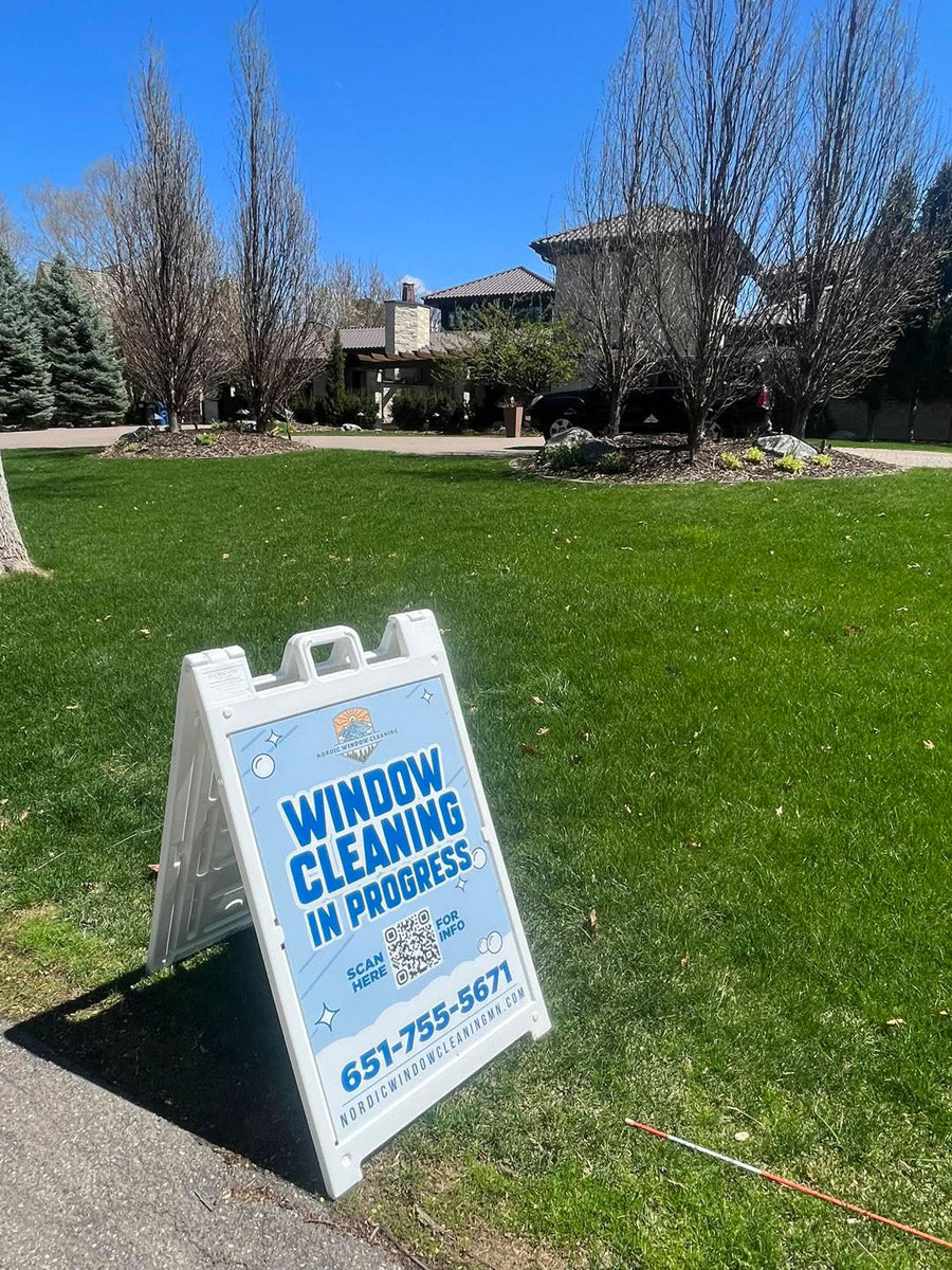 Nordic Window Cleaning A-frame sign on residential lawn promoting “Window Cleaning In Progress” with QR code for contact info, printed by WCR Marketing.