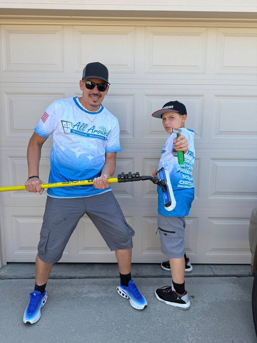 Matching All Around Window Washing dye-sublimated jerseys worn outdoors with tools, displaying crisp gradient logo design, printed by WCR Marketing.