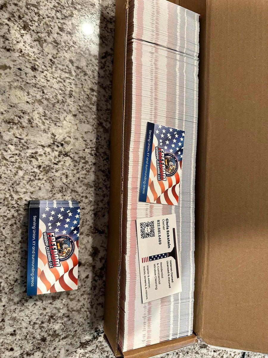Freedom Window Cleaning business cards with American flag design, displayed in box after production, printed by WCR Marketing.