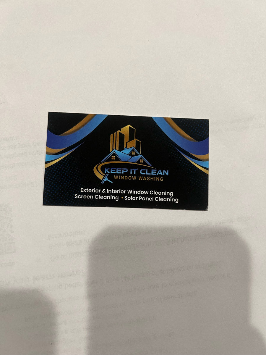 Keep It Clean Window Washing business card on white background, showcasing blue and gold curved design and company logo, printed by WCR Marketing.