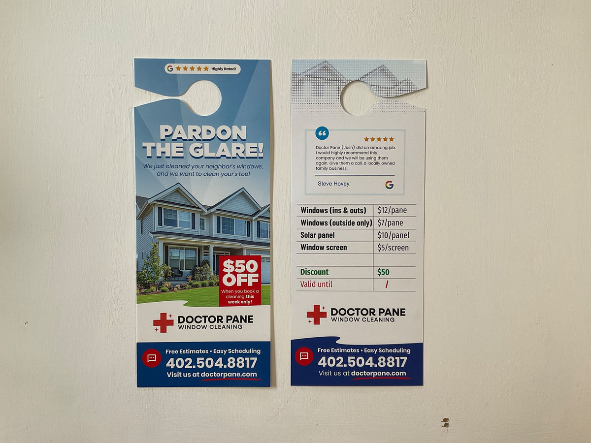 Two door hangers for Doctor Pane window cleaning on a wall, printed by WCR Marketing.