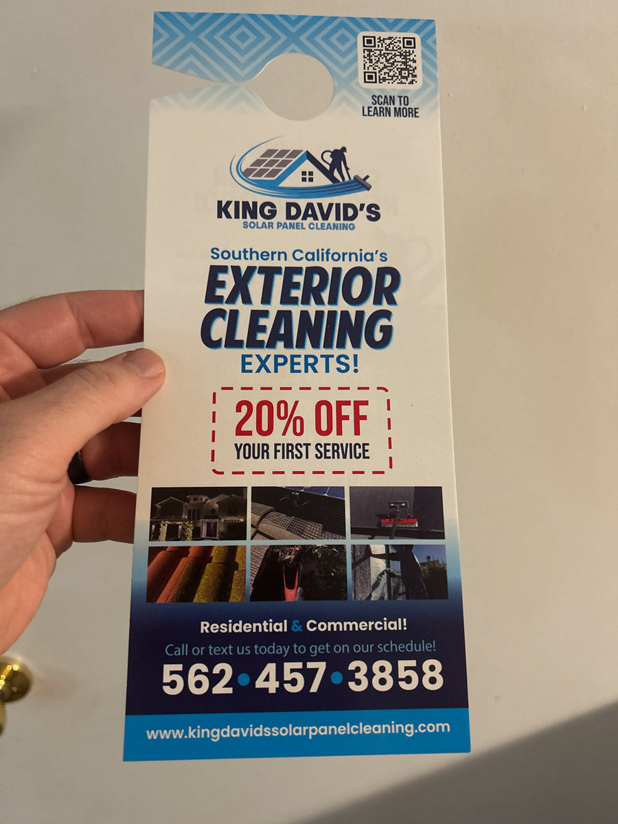 King David’s Solar Panel Cleaning door hanger promoting 20% off first service, held against light background with blue header, printed by WCR Marketing.