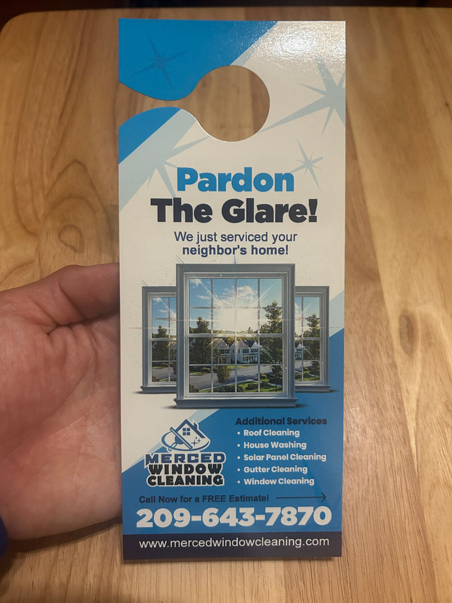 Merced Window Cleaning door hanger back side showing roof, house, and solar panel cleaning photos with $25 off coupon, printed by WCR Marketing.