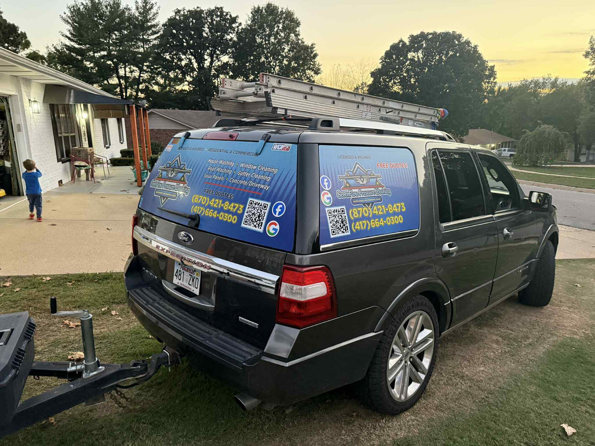 Rear view of Seven Flag Pressure Washing SUV with vinyl wrap and attached trailer, printed by WCR Marketing.