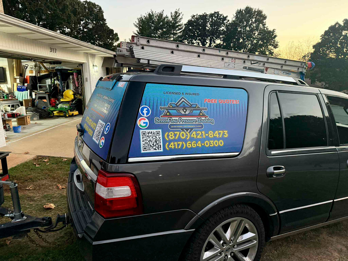 Side view of Seven Flag Pressure Washing SUV wrap with contact information and ladders on roof rack, printed by WCR Marketing.