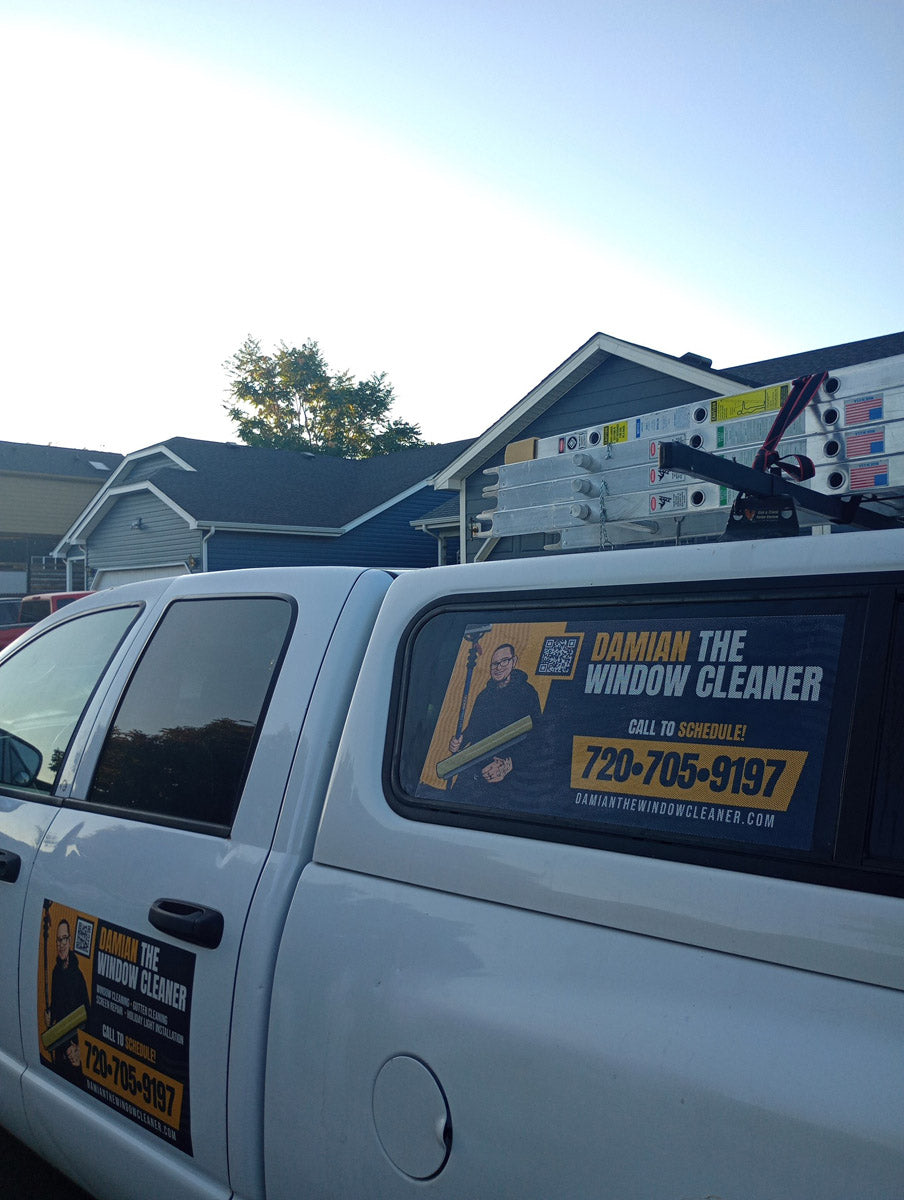 Side view of Seven Flag Pressure Washing SUV wrap with contact information and ladders on roof rack, printed by WCR Marketing.