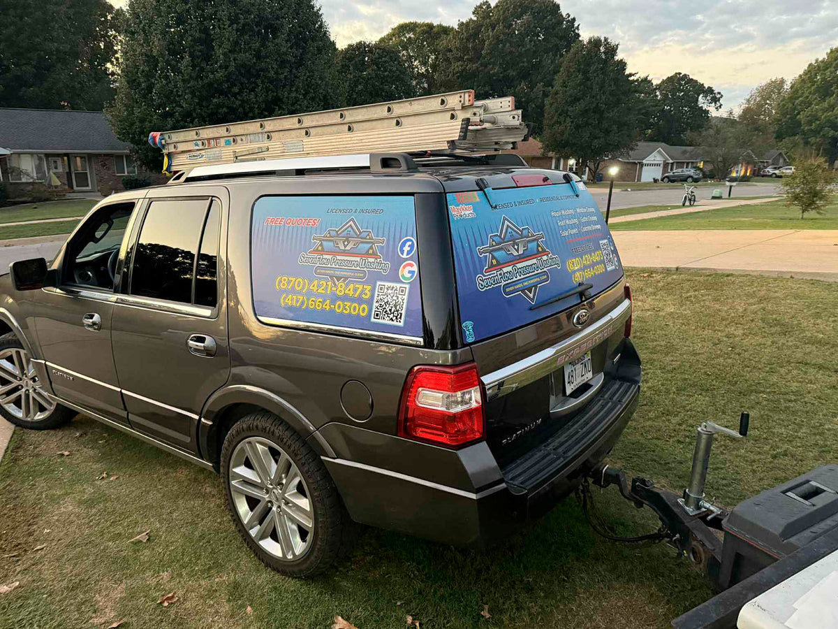 Branded Ford Expedition SUV with Seven Flag Pressure Washing vinyl wrap and ladders mounted on roof, printed by WCR Marketing.