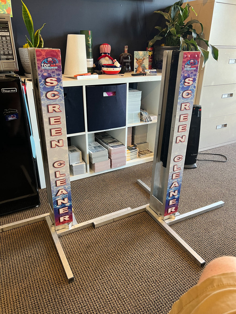 Pair of XERO Screen Cleaner custom decal units displayed indoors on aluminum frames, showing professional contractor branding, printed by WCR Marketing.