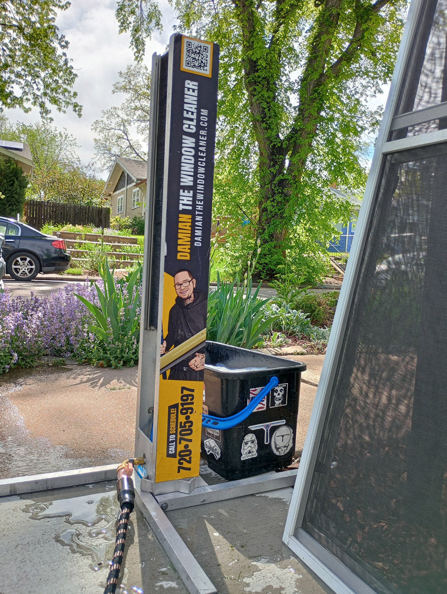Damian The Window Cleaner custom XERO Screen Cleaner decal in use, showing full artwork with character logo and yellow accent branding, printed by WCR Marketing.
