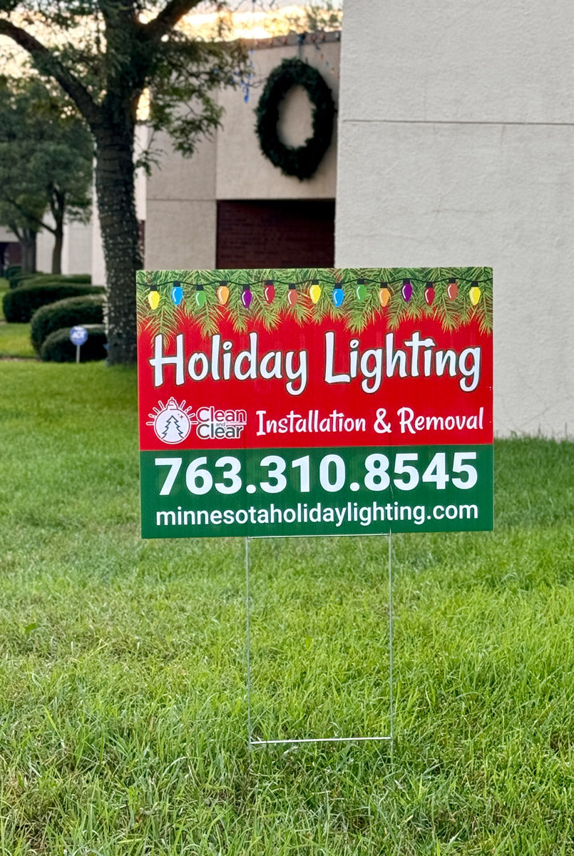 Clean and Clear Holiday Lighting installation and removal yard sign staked in a manicured office park lawn, printed by WCR Marketing.