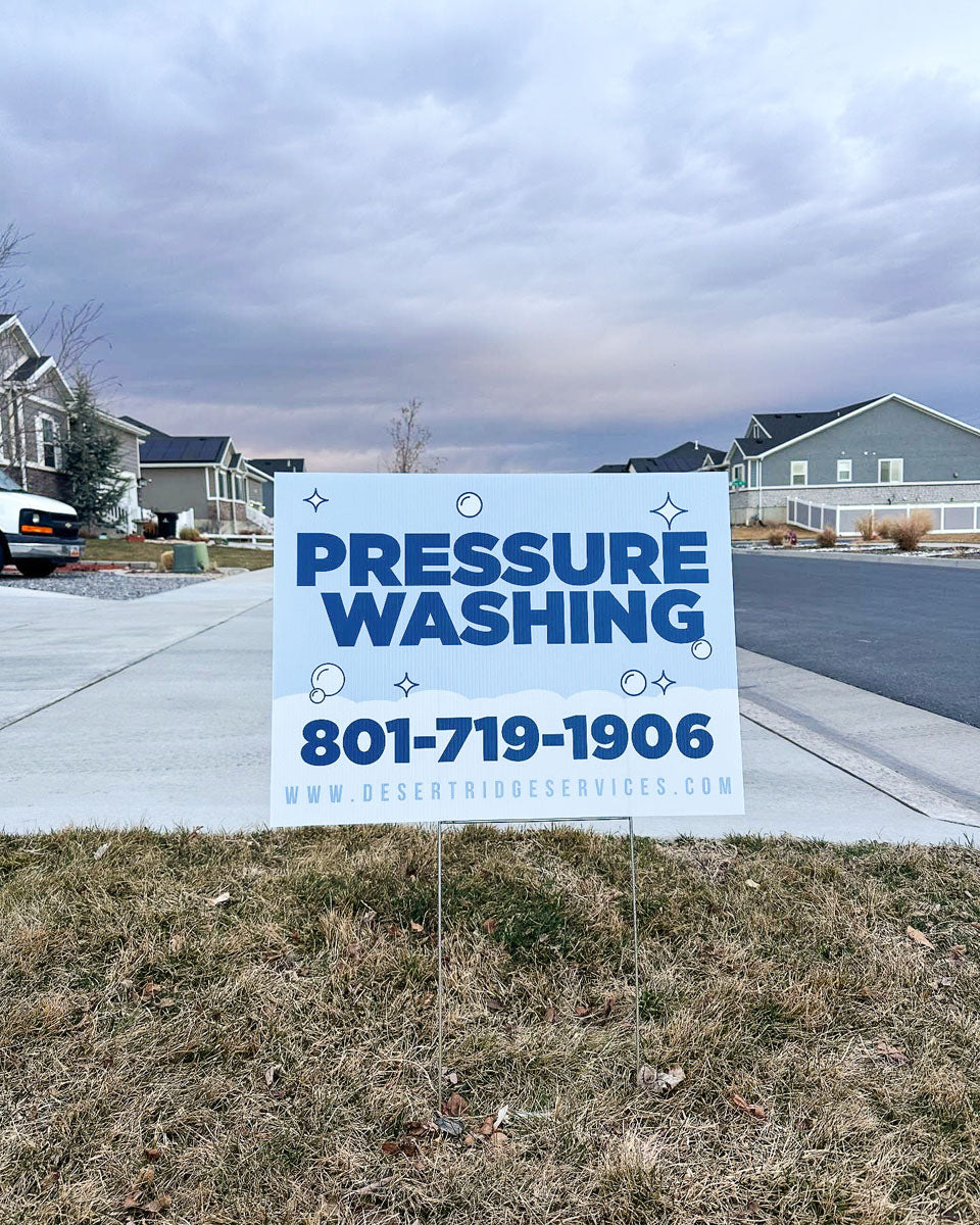 Pressure washing yard sign for Desert Ridge Services displayed on a residential lawn with cloudy sky, printed by WCR Marketing.