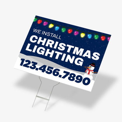 Blue Christmas lighting yard sign featuring snowman graphic, snow base, and light string border
